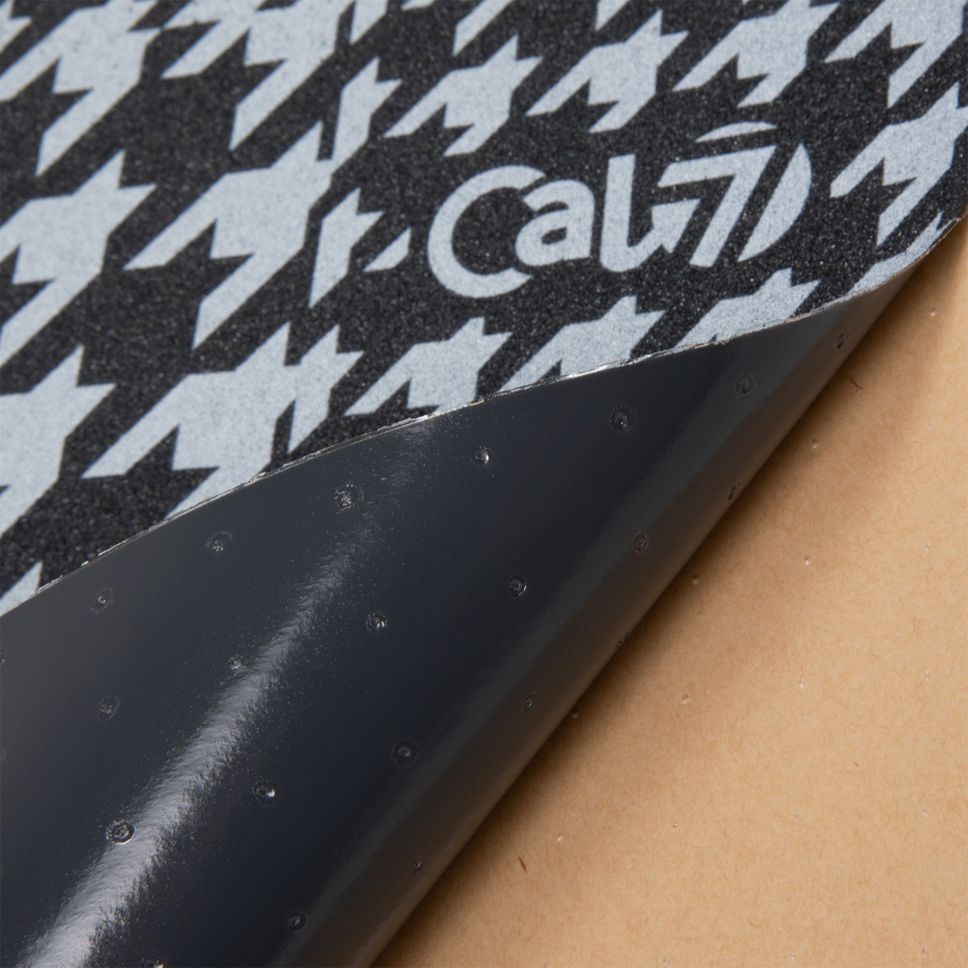 Cal 7 black skateboard griptape with tweed design